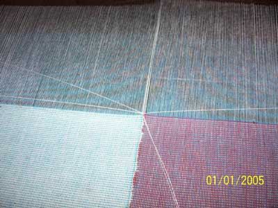 Conversion of plain power looms into continuous weft feeding looms - Photo